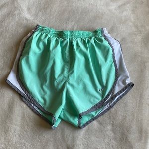 Mint green running shorts with gray and white side details.
